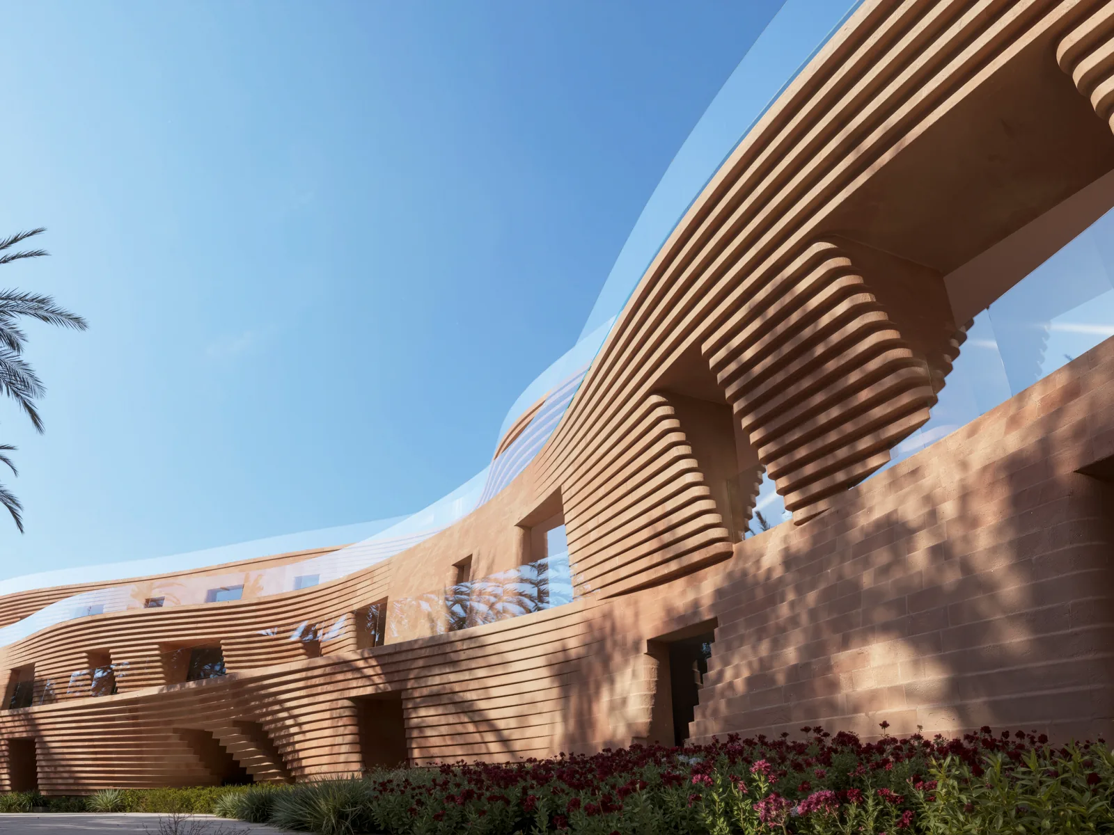 Ribbed terracotta facade curving above the planting, its horizontal banding drawn from coral