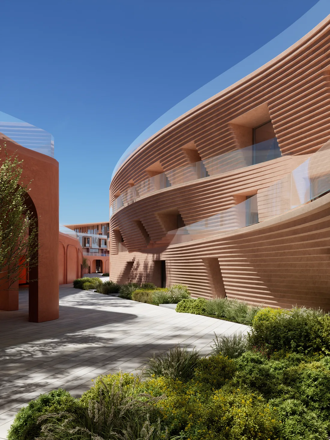 A curved, ribbed terracotta facade at Mira Coral Bay seen from a planted garden walkway