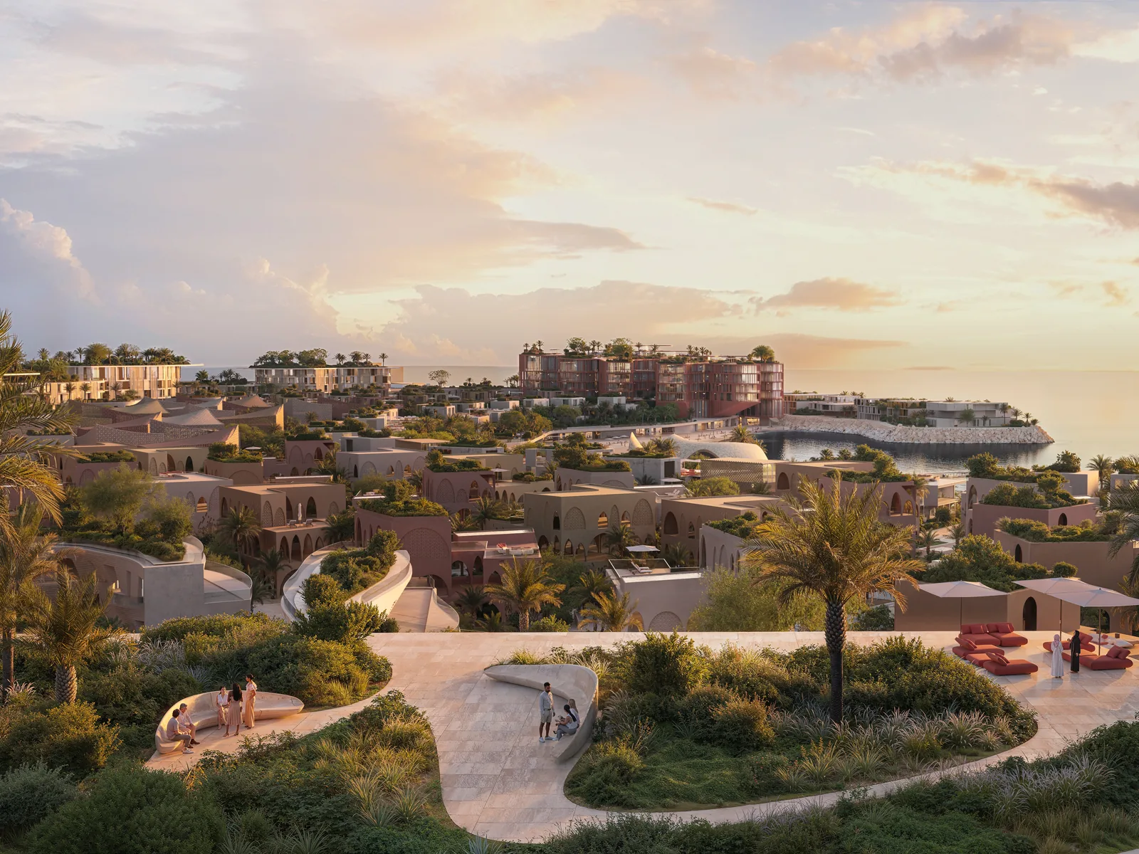 Villa clusters with planted roofs and landscaped terraces above the bay at sunset